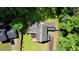 Aerial view highlights a house with a deck and vibrant yard, tucked within a lush, tree-lined property at 2926 Swarthmore Dr, Lawrenceville, GA 30044