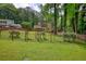 Backyard featuring a well-maintained lawn, mature trees, and fenced perimeter at 2926 Swarthmore Dr, Lawrenceville, GA 30044