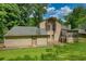 Backyard with a lush lawn showcasing the home's exterior with a patio and deck at 2926 Swarthmore Dr, Lawrenceville, GA 30044