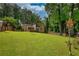 Expansive backyard with lush green lawn, mature trees, and a wooden fence, perfect for outdoor activities at 2926 Swarthmore Dr, Lawrenceville, GA 30044