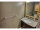 Close-up of a well-lit bathroom vanity with a granite countertop and wooden-framed mirror at 2926 Swarthmore Dr, Lawrenceville, GA 30044