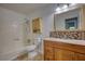 Bright bathroom featuring a shower-tub combo, granite countertops, and wood vanity at 2926 Swarthmore Dr, Lawrenceville, GA 30044