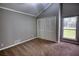 Cozy bedroom features high vaulted ceiling, neutral colors, carpet and natural light from a window at 2926 Swarthmore Dr, Lawrenceville, GA 30044