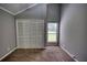 Bedroom featuring neutral decor, a window, and a spacious closet for storage at 2926 Swarthmore Dr, Lawrenceville, GA 30044