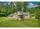 Back of two-story home featuring a spacious green lawn, a deck, and sunroom at 2926 Swarthmore Dr, Lawrenceville, GA 30044