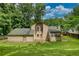Back of two-story home featuring a spacious green lawn, a deck, and sunroom at 2926 Swarthmore Dr, Lawrenceville, GA 30044