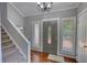Elegant foyer showcasing hardwood floors, a staircase, and a front door with glass accents at 2926 Swarthmore Dr, Lawrenceville, GA 30044