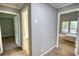 Hallway with neutral colored walls, carpet and access to bedrooms and bath at 2926 Swarthmore Dr, Lawrenceville, GA 30044