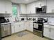 Well-lit kitchen featuring stainless steel appliances and modern white cabinetry at 2926 Swarthmore Dr, Lawrenceville, GA 30044