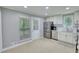 Bright kitchen features stainless steel appliances, white cabinets and tiled backsplash at 2926 Swarthmore Dr, Lawrenceville, GA 30044