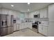 Kitchen featuring white cabinets, tile backsplash, stainless steel appliances, and tile flooring at 2926 Swarthmore Dr, Lawrenceville, GA 30044