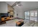 Cozy living room with stone fireplace, modern ceiling fan, and natural light at 2926 Swarthmore Dr, Lawrenceville, GA 30044