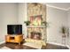 Living room with stacked stone fireplace, wood floors, and natural lighting at 2926 Swarthmore Dr, Lawrenceville, GA 30044