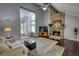 Bright living room showcasing a stone fireplace, and a large window allowing for natural light at 2926 Swarthmore Dr, Lawrenceville, GA 30044
