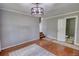 Spacious living room featuring hard wood floors and adjacent to a bathroom and a stairwell at 2926 Swarthmore Dr, Lawrenceville, GA 30044
