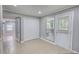 Neutral-toned room featuring tiled flooring, a window, closet, and a door leading to the outside at 2926 Swarthmore Dr, Lawrenceville, GA 30044