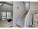 View of staircase connecting floors, with a glimpse of the living room and sliding glass doors at 2926 Swarthmore Dr, Lawrenceville, GA 30044