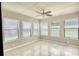Light-filled sunroom with tiled floors, ceiling fan, and large windows at 2926 Swarthmore Dr, Lawrenceville, GA 30044