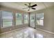 Bright sunroom with neutral walls, tile flooring, a ceiling fan, and multiple windows letting in natural light at 2926 Swarthmore Dr, Lawrenceville, GA 30044