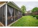 Backyard with a screened porch, privacy fence, and lush green lawn offering a private outdoor retreat at 3637 Sweet Ashley Ln, Loganville, GA 30052