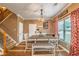 A dining area features a pendant light fixture, a table with chairs and a bench, and a staircase at 3637 Sweet Ashley Ln, Loganville, GA 30052