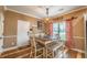 A dining area features a pendant light fixture and a table with chairs and a bench at 3637 Sweet Ashley Ln, Loganville, GA 30052