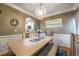 A dining room features a unique light fixture over a table with chairs and a bench at 3637 Sweet Ashley Ln, Loganville, GA 30052
