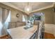 A dining room features a light fixture over a table with chairs and a bench with a buffet in the background at 3637 Sweet Ashley Ln, Loganville, GA 30052