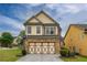 Lovely home featuring a stone-accented garage and neutral colored siding, set against a bright blue sky at 3637 Sweet Ashley Ln, Loganville, GA 30052