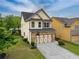 View of a two-story home featuring a well-kept lawn and a basketball hoop in the driveway at 3637 Sweet Ashley Ln, Loganville, GA 30052