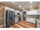 A bright kitchen features stainless steel appliances, granite countertops, white cabinets, and hardwood floors at 3637 Sweet Ashley Ln, Loganville, GA 30052