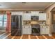 This kitchen features stainless steel appliances, granite countertops, and white cabinets with hardwood floors at 3637 Sweet Ashley Ln, Loganville, GA 30052