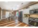 A cozy kitchen area features stainless steel appliances, granite countertops, white cabinets, and hardwood floors at 3637 Sweet Ashley Ln, Loganville, GA 30052
