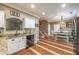 A cozy kitchen features white cabinets, stainless steel appliances, granite countertops, and hardwood floors at 3637 Sweet Ashley Ln, Loganville, GA 30052