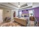 A bedroom features a unique light fixture and a large bed with a sitting chair and closet at 3637 Sweet Ashley Ln, Loganville, GA 30052