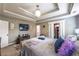 Bright main bedroom featuring a tray ceiling, and an ensuite bathroom and walk-in closet at 3637 Sweet Ashley Ln, Loganville, GA 30052