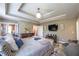 Spacious main bedroom featuring a tray ceiling, elegant lighting, and a cozy sitting area at 3637 Sweet Ashley Ln, Loganville, GA 30052