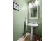 Stylish half bathroom with a pedestal sink and modern fixtures at 508 Vinings Forest Se Ct, Smyrna, GA 30080