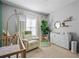 Neutral Bedroom featuring a crib, rocker, and dresser with gold accents at 508 Vinings Forest Se Ct, Smyrna, GA 30080