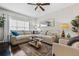 Bright living room featuring a sectional sofa, large window, and a ceiling fan at 508 Vinings Forest Se Ct, Smyrna, GA 30080