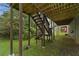 Backyard view of staircase leading to a deck, complemented by surrounding greenery at 6420 Marbut Rd, Lithonia, GA 30058