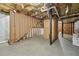Unfinished basement, ready for customization with exposed beams and concrete floors at 6420 Marbut Rd, Lithonia, GA 30058