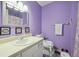 This is a cozy bathroom featuring a vanity, toilet, and framed wall art at 6420 Marbut Rd, Lithonia, GA 30058