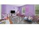 Playful bedroom with purple walls, plush carpet, and plenty of toys at 6420 Marbut Rd, Lithonia, GA 30058