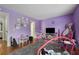 Playful bedroom features light purple walls, plush carpet and colorful decor at 6420 Marbut Rd, Lithonia, GA 30058