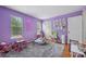 Vibrant bedroom features light purple walls, plush carpet and colorful decor at 6420 Marbut Rd, Lithonia, GA 30058