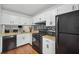 Bright kitchen featuring black appliances, white cabinets, and a gas stovetop at 6420 Marbut Rd, Lithonia, GA 30058