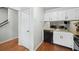 Efficient kitchen with white cabinets, wood countertop, and essential appliances at 6420 Marbut Rd, Lithonia, GA 30058