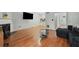 Open-concept living room with hardwood floors, fireplace, and a view into the kitchen at 6420 Marbut Rd, Lithonia, GA 30058