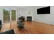 Open-concept living room with fireplace, hardwood floors, sliding glass doors, and a TV at 6420 Marbut Rd, Lithonia, GA 30058